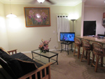 Living area with fold down sofa bed and flat screen TV.